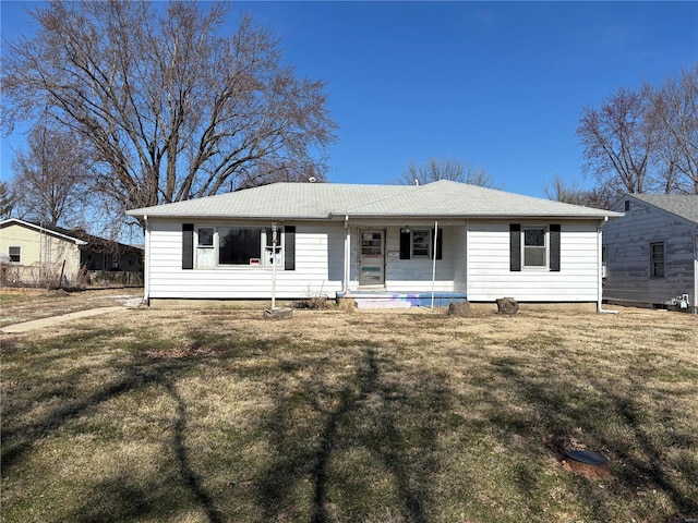 ranch-style house featuring roof with shingles, a porch, and a front lawn