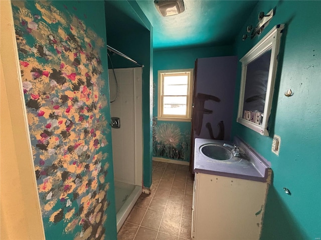 full bathroom with tile patterned flooring, a stall shower, vanity, and baseboards