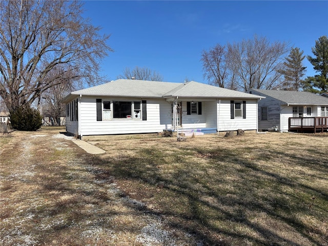 rear view of property with a lawn