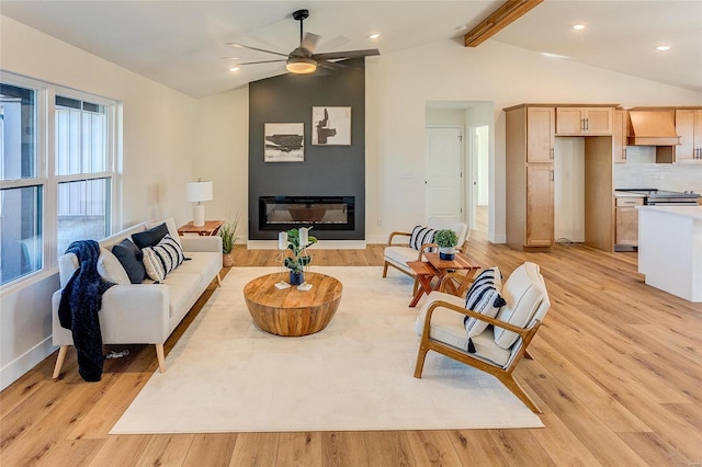 living area with light wood finished floors, a fireplace, and vaulted ceiling with beams