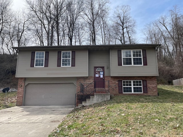 bi-level home featuring brick siding, a front lawn, concrete driveway, and a garage