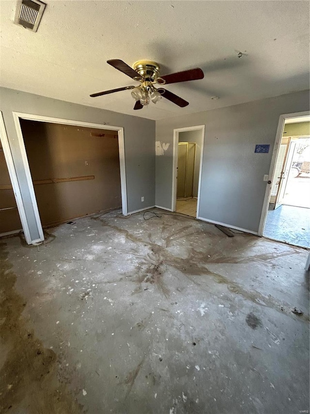 unfurnished bedroom featuring a ceiling fan, visible vents, and a textured ceiling