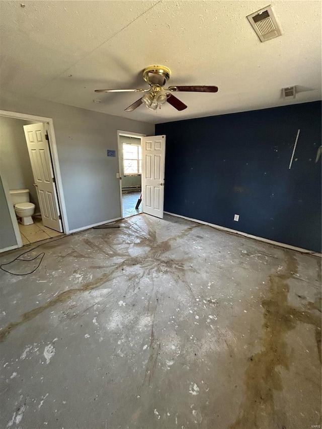 unfurnished bedroom featuring connected bathroom, baseboards, visible vents, and a textured ceiling