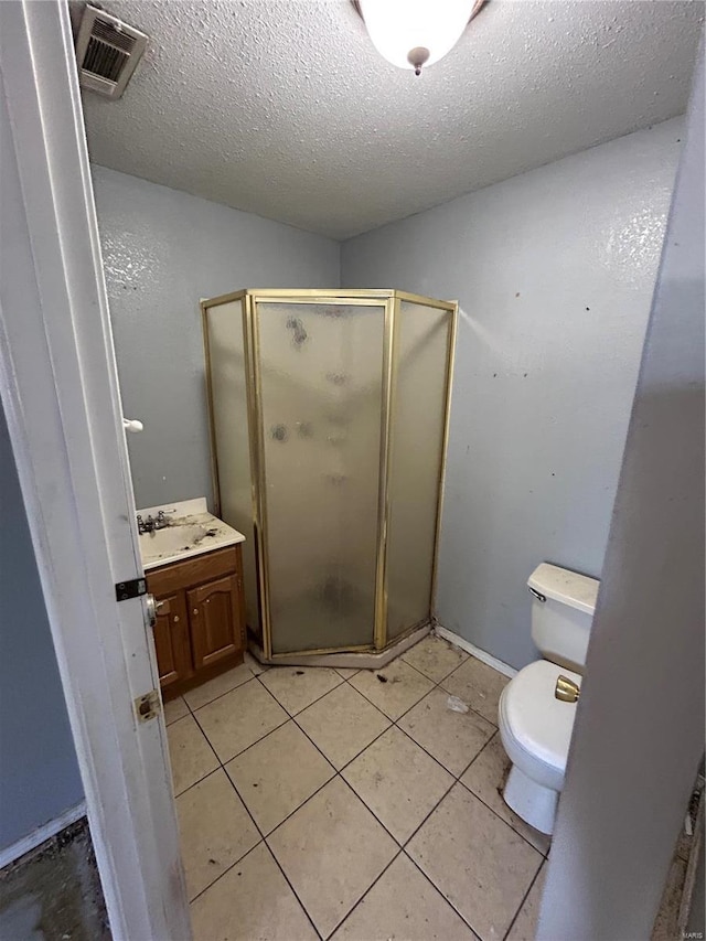 full bathroom with vanity, visible vents, a shower stall, a textured ceiling, and toilet