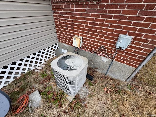 details with central air condition unit and brick siding