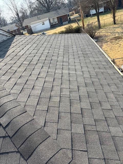 exterior details featuring a shingled roof