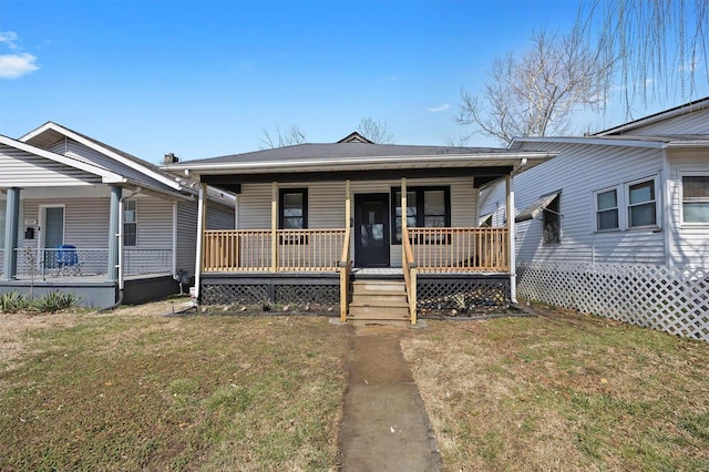 bungalow featuring a porch and a front lawn