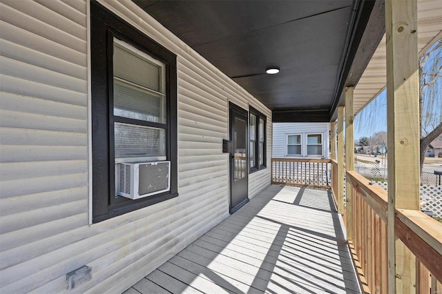 deck featuring cooling unit and covered porch