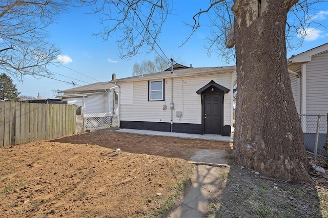 rear view of house with fence