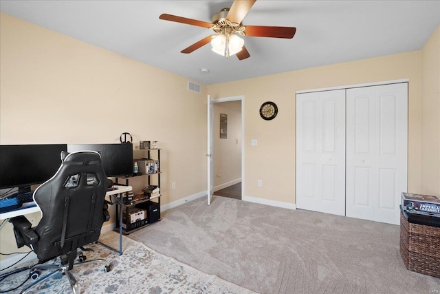 office featuring visible vents, baseboards, ceiling fan, and carpet flooring