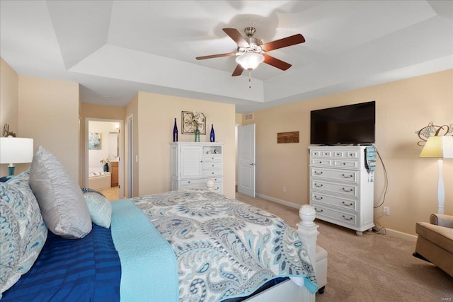 bedroom with a raised ceiling, a ceiling fan, baseboards, and light carpet