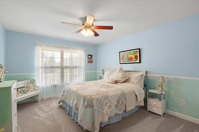 bedroom with ceiling fan, baseboards, and carpet floors