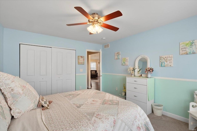 bedroom featuring carpet, baseboards, visible vents, ceiling fan, and a closet