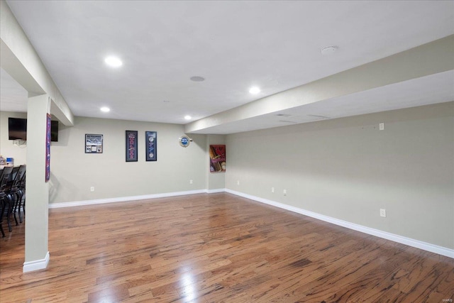 finished basement featuring recessed lighting, wood finished floors, and baseboards