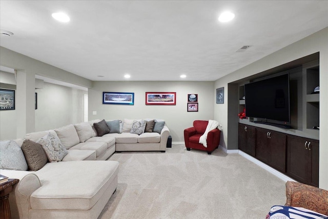 living area featuring recessed lighting, visible vents, and light carpet