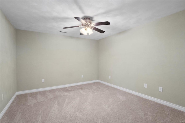 unfurnished room featuring visible vents, baseboards, carpet, and a ceiling fan