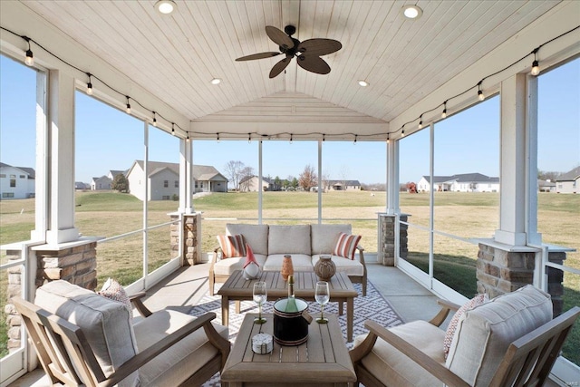 sunroom featuring track lighting, ceiling fan, a residential view, lofted ceiling, and wooden ceiling