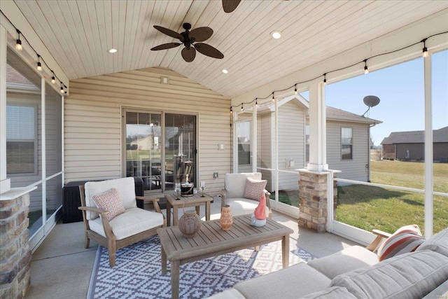 sunroom / solarium with lofted ceiling, wooden ceiling, and ceiling fan