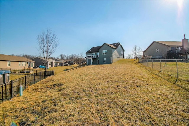 view of yard with a residential view and fence