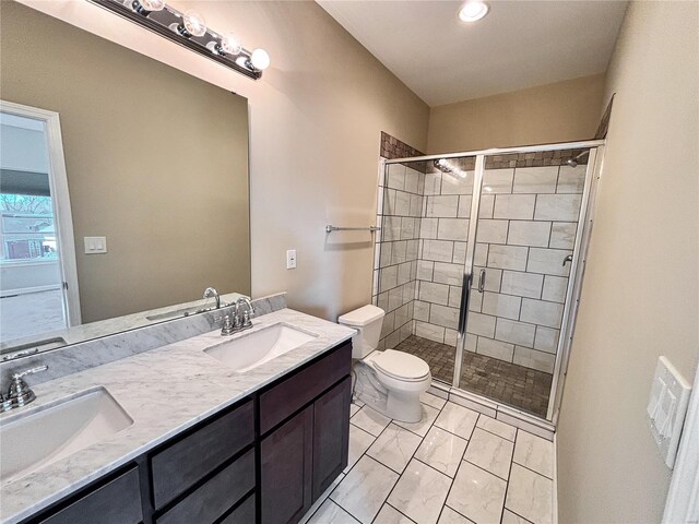 bathroom featuring a sink, toilet, and a shower stall