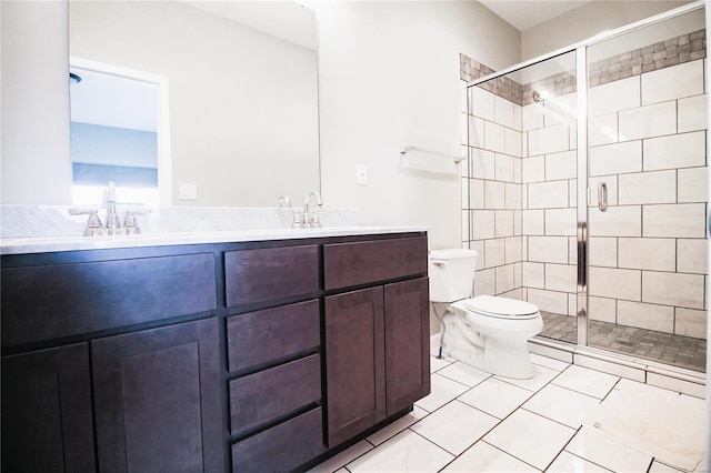full bath featuring toilet, a stall shower, double vanity, and a sink