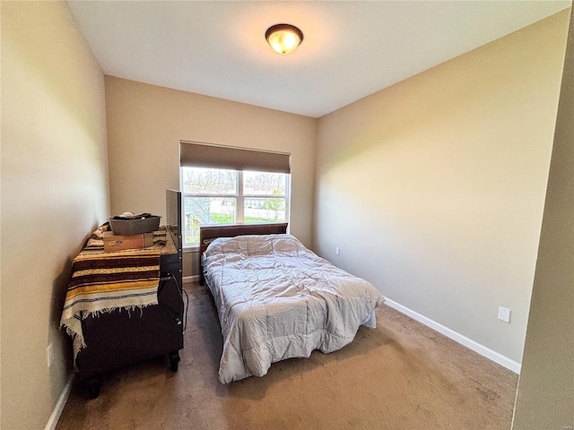 bedroom featuring carpet and baseboards