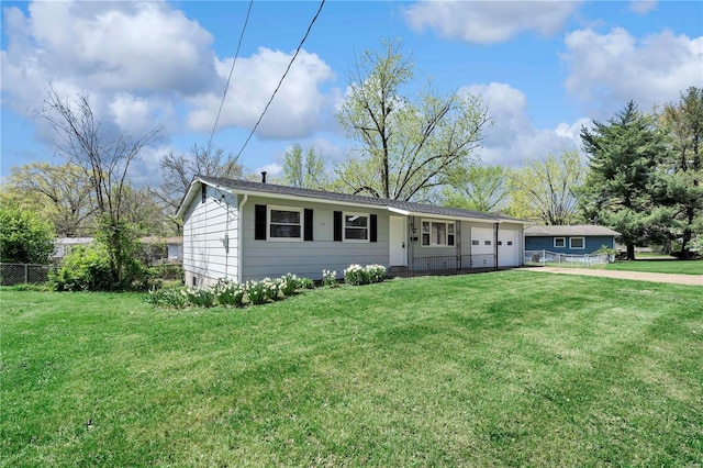 ranch-style house featuring concrete driveway, an attached garage, fence, and a front yard