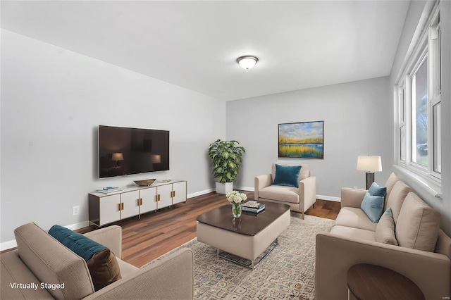 living area featuring wood finished floors and baseboards