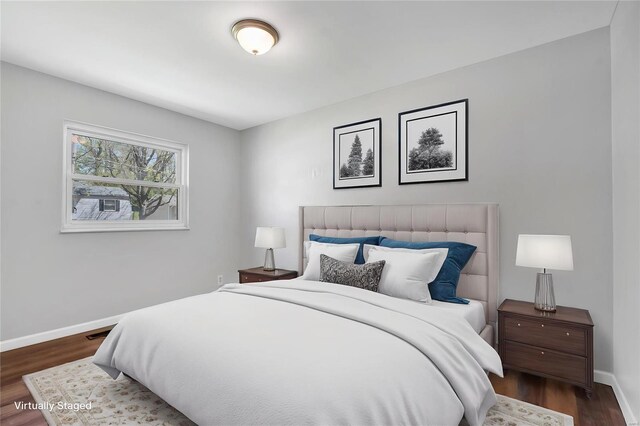 bedroom featuring baseboards and dark wood-style floors