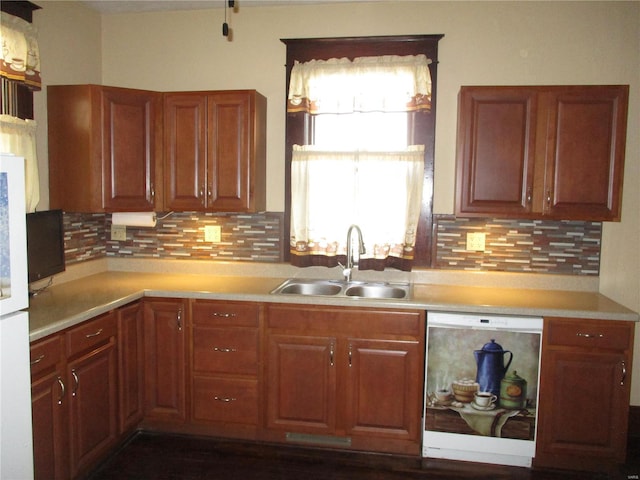 kitchen with dishwasher, light countertops, decorative backsplash, brown cabinets, and a sink