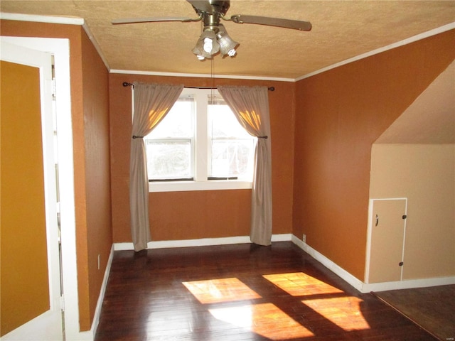 bonus room with baseboards, a textured ceiling, wood finished floors, and a ceiling fan