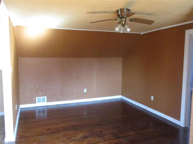 bonus room with a ceiling fan, baseboards, visible vents, vaulted ceiling, and dark wood-type flooring