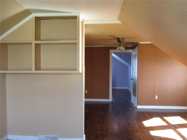 additional living space with visible vents, ceiling fan, baseboards, lofted ceiling, and wood finished floors