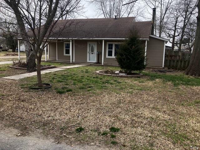 ranch-style house with a front yard and fence