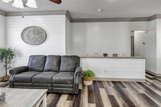 living room with a ceiling fan, wood finished floors, and ornamental molding