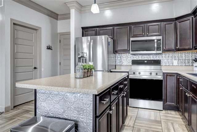 kitchen with crown molding, light countertops, tasteful backsplash, and stainless steel appliances