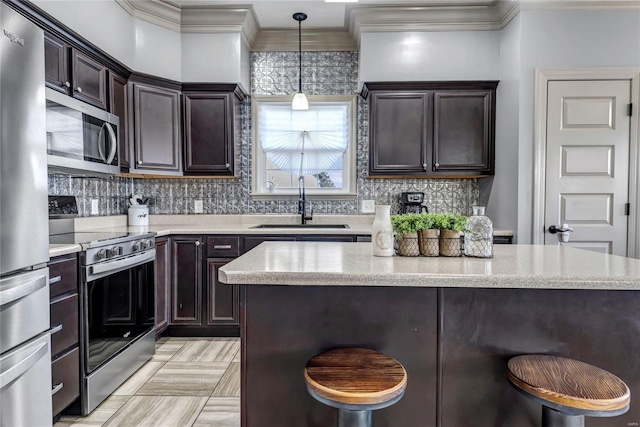 kitchen with a sink, a kitchen island, tasteful backsplash, dark brown cabinetry, and appliances with stainless steel finishes