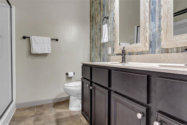 bathroom with tile patterned floors, toilet, vanity, and baseboards