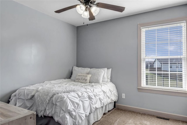 bedroom with visible vents, ceiling fan, baseboards, and carpet floors