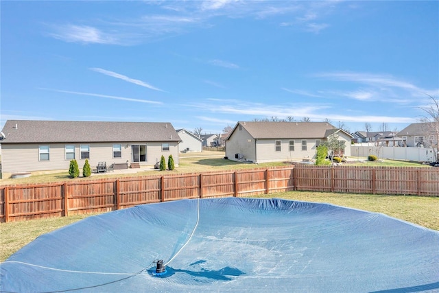 view of pool with a residential view and a fenced backyard