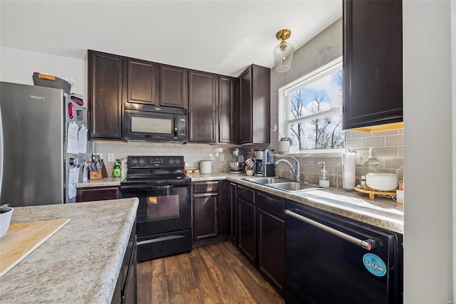 kitchen with a sink, black appliances, light countertops, dark brown cabinetry, and backsplash