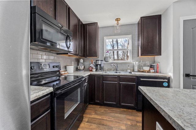 kitchen with dark wood-style floors, a sink, black appliances, dark brown cabinetry, and tasteful backsplash