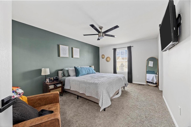 carpeted bedroom with baseboards and ceiling fan