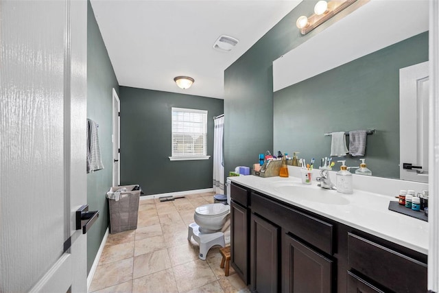 bathroom featuring visible vents, baseboards, toilet, and vanity