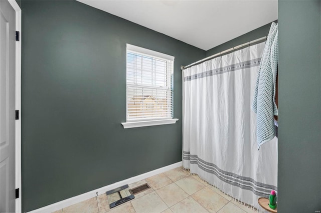 full bathroom featuring curtained shower, tile patterned floors, and baseboards