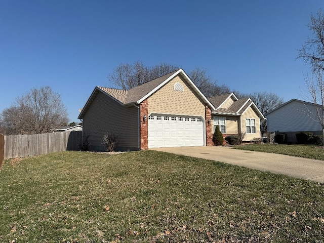 view of front of property featuring a front lawn, fence, concrete driveway, an attached garage, and brick siding