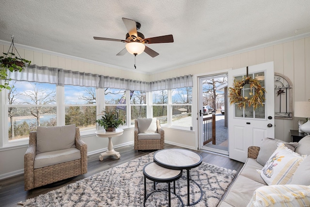 sunroom / solarium featuring a ceiling fan