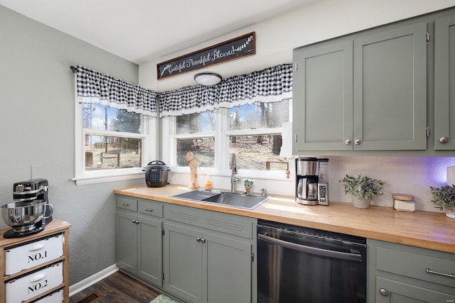 kitchen featuring dishwasher, a wealth of natural light, wooden counters, and a sink