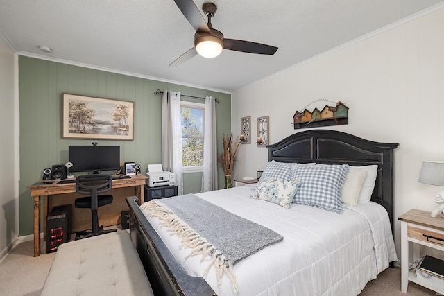 carpeted bedroom featuring baseboards, a textured ceiling, ornamental molding, and a ceiling fan