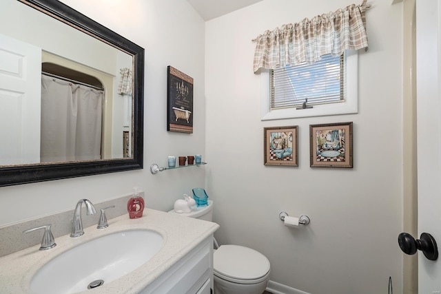 bathroom featuring vanity, toilet, and a shower with curtain